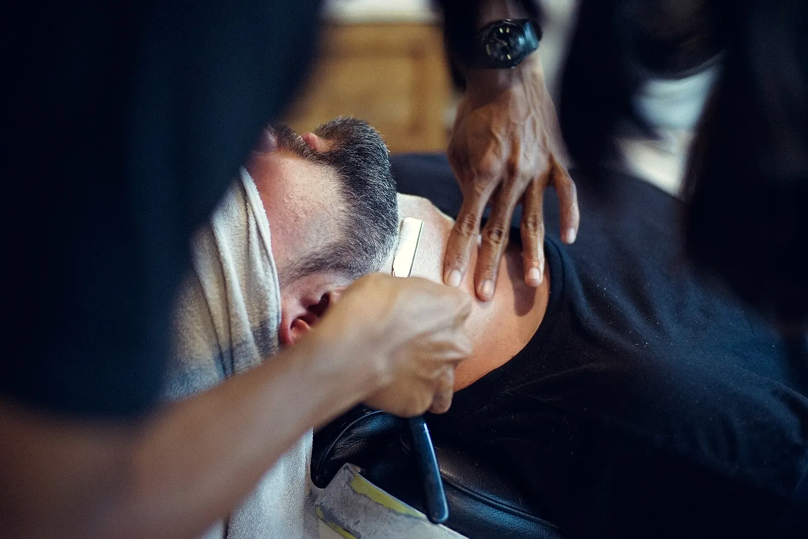 A barber giving a customer a straight-razor shave